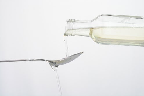 Pouring coconut oil in a spoon