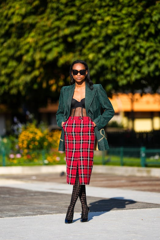 Emilie Joseph wearing a corset and plaid pencil skirt