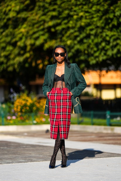 Emilie Joseph wearing a corset and a checked pencil skirt