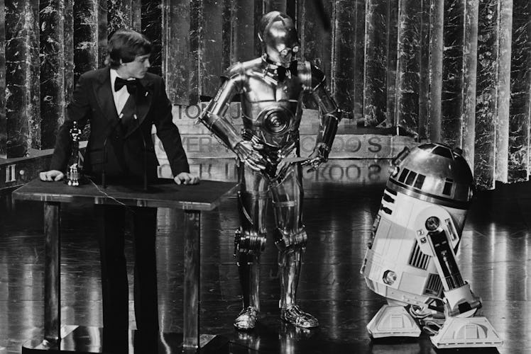 Actor Mark Hamill presenting an award with his Star Wars co-stars C3PO and R2D2, at the 50th Academy...