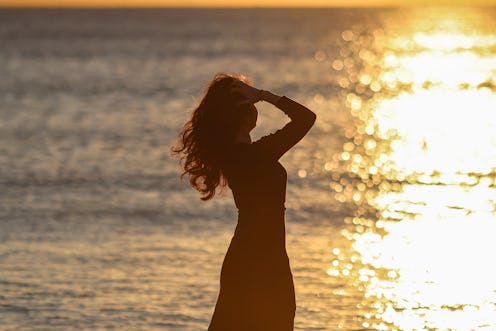 woman at the beach during sunset