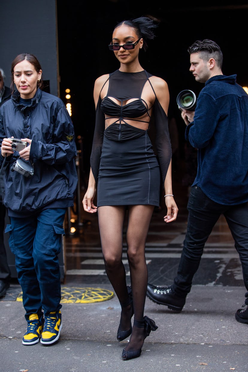 London Fashion Week Street Style Jourdan Dunn wearing a black dress.