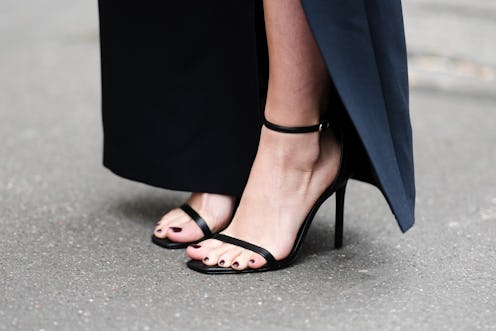PARIS, FRANCE - FEBRUARY 04: Diane Batoukina wears a high waist black slit / split midi skirt from C...