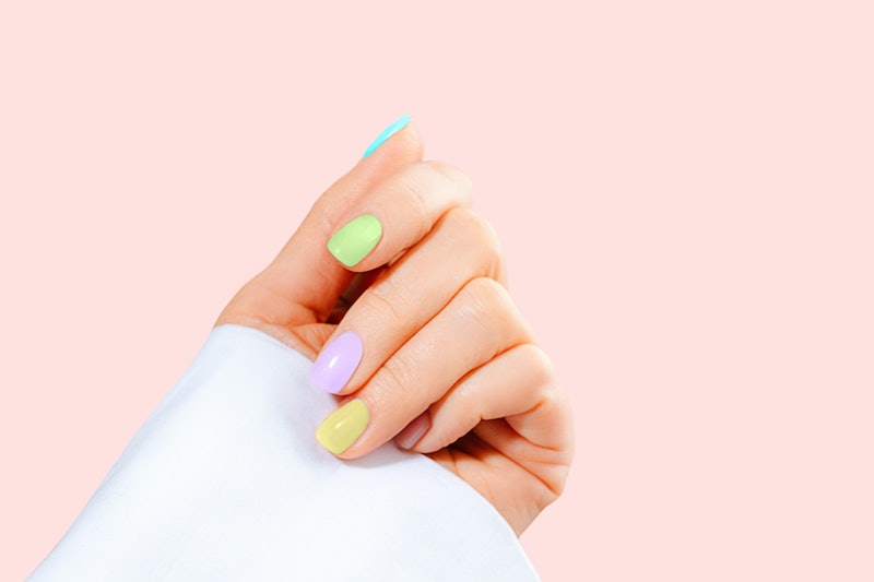 Elegant woman's hand with pastel color manicure on Easter Holiday. Stylish trendy manicure.  Trendy ...