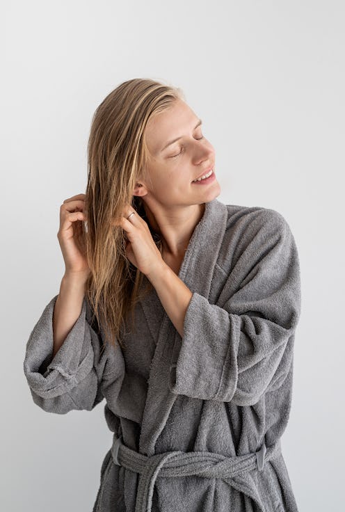 woman massaging her head after a shower