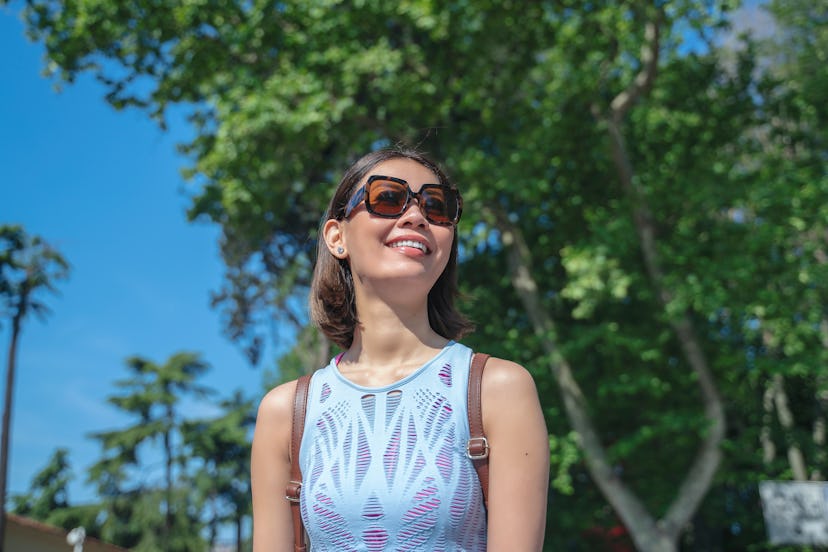 Portrait of woman, tourist, sunny day, sunglasses, city street