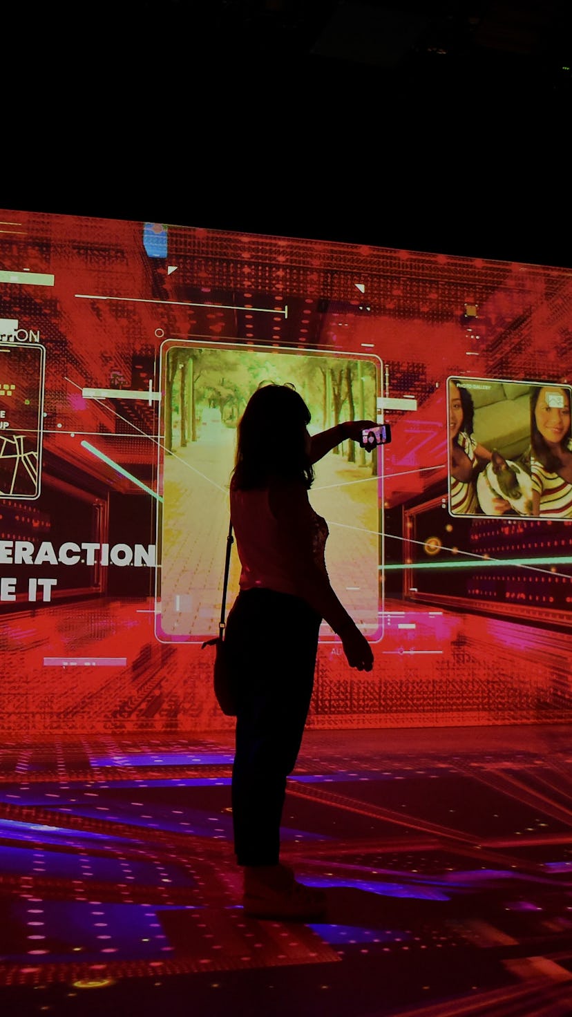 A woman uses her phone at the Mobile World Congress (MWC) fair in Barcelona on June 28, 2021. (Photo...