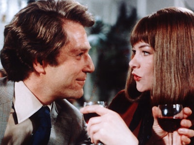 George Segal, US actor, and Glenda Jackson, British actress, drinking red wine in a publicity still ...