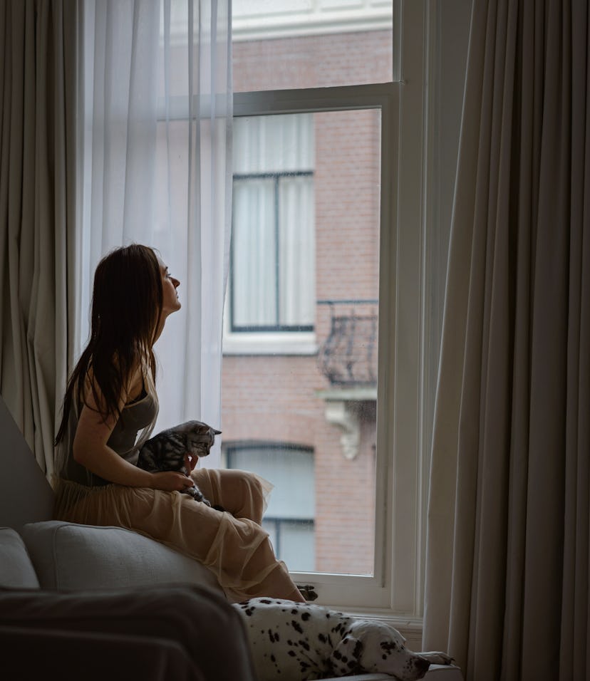 woman looking out window