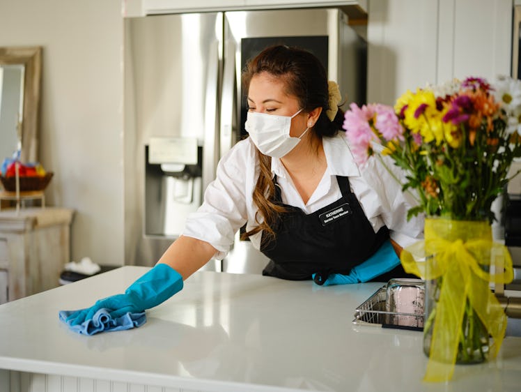 A professional housecleaner at work cleaning a home.