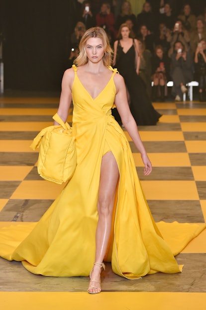 Karlie Kloss walks the Off-White runway in a yellow gown during Paris Fashion Week.