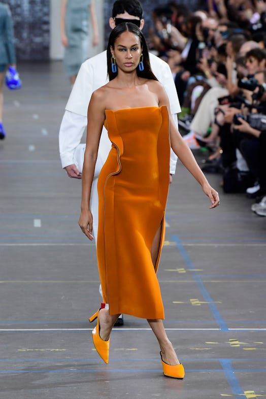 Joan Smalls in an orange, strapless gown at the Off-White show during Paris Fashion Week.