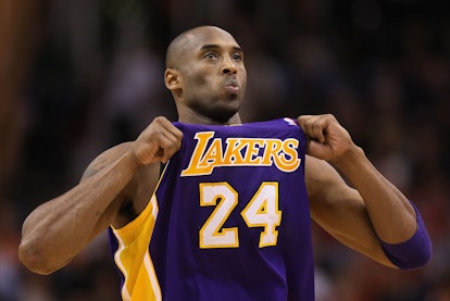 PHOENIX, AZ - FEBRUARY 19:  Kobe Bryant #24 of the Los Angeles Lakers adjusts his jersey during the ...