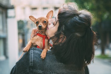 A young woman poses with her newly-adopted puppy for an Instagram picture.