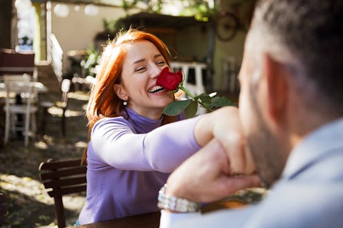 Couple having romantic moment in cozy cafe. The astrology of valentine's day 2022 will affect these ...