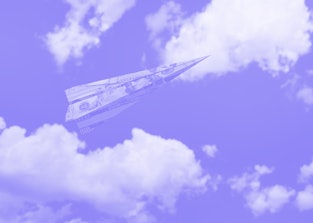 Paper airplane folded from US dollar banknote flying in sky. Blue sky with white clouds background. ...