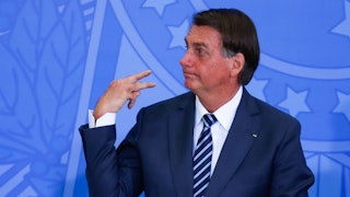 Brazilian President Jair Bolsonaro gestures as he attends a ceremony on retirement issues of the Soc...