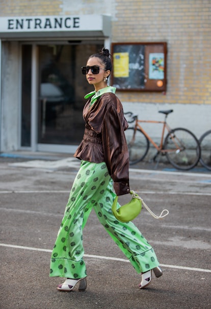 COPENHAGEN, DENMARK - FEBRUARY 02: Malvika Sheth is seen wearing brown top, green overall with print...