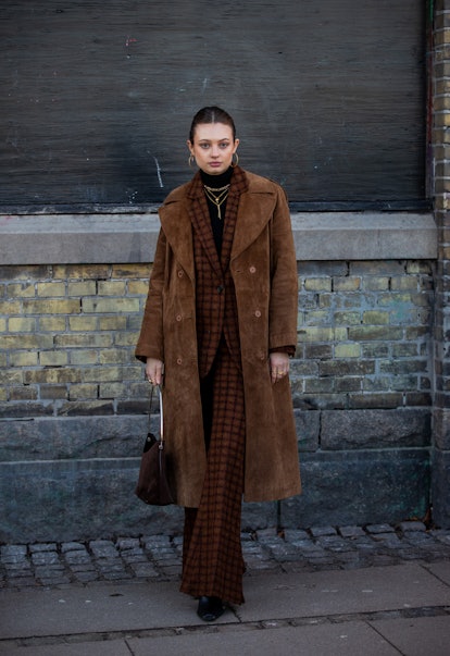 COPENHAGEN, DENMARK - FEBRUARY 02: Emilie Billington seen wearing brown coat, checkered suit outside...