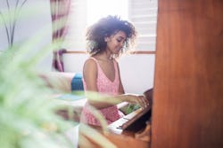 A woman plays the piano. Here's your daily horoscope for February 7 2022.