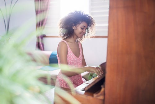A woman plays the piano. Here’s your daily horoscope for February 7 2022.
