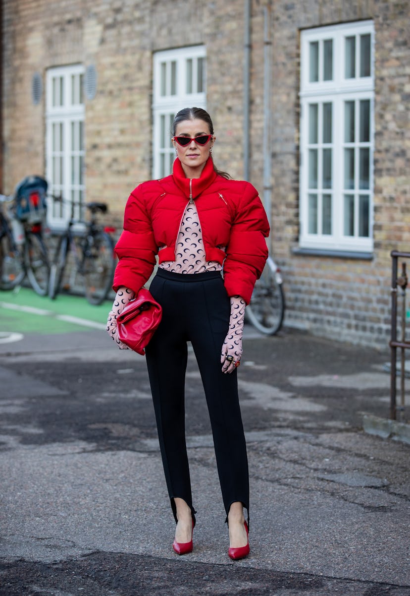 COPENHAGEN, DENMARK - FEBRUARY 02: Nina Sandbech seen wearing red cropped puffer jacket, gloves, bla...