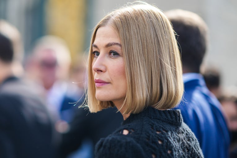 PARIS, FRANCE - SEPTEMBER 28: Rosamund Pike wears a black wool braided / cut-out pullover, outside D...