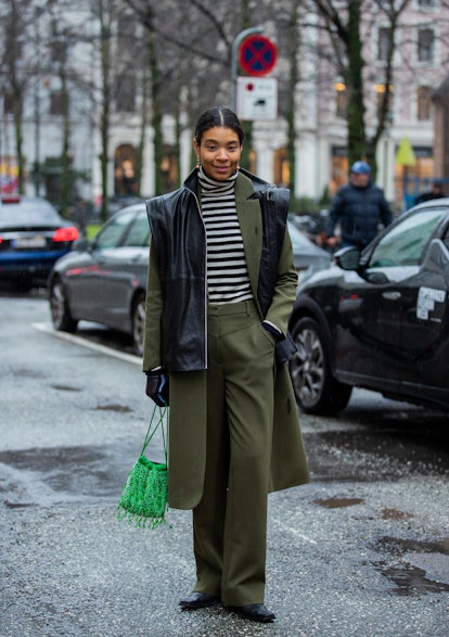 COPENHAGEN, DENMARK - FEBRUARY 03: Sara Flaaen Licius wearing olive green pants, black vest, coat ou...