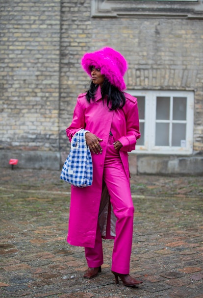 COPENHAGEN, DENMARK - FEBRUARY 02:  Mona M. Ali is seen wearing pink hat, trench coat, pants, blue w...