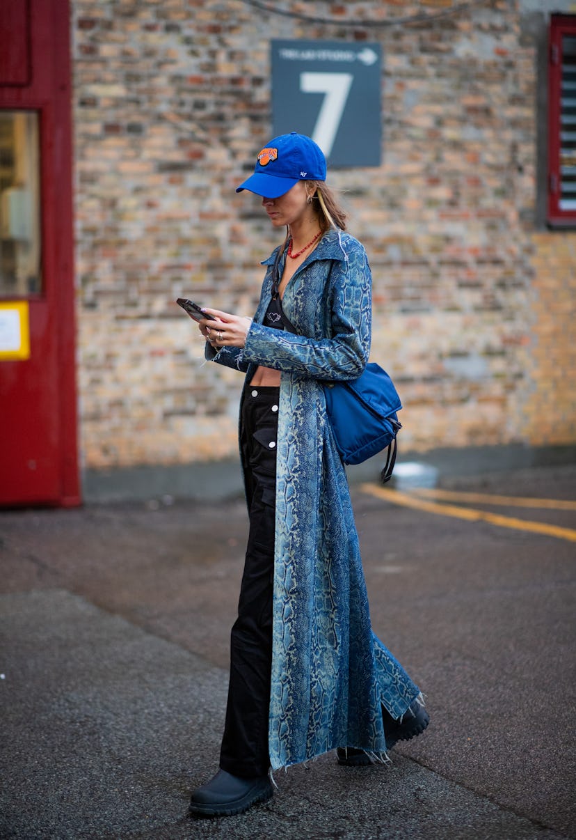 COPENHAGEN, DENMARK - FEBRUARY 01: Anna Wink seen wearing copped top, cap, black pants, coat outside...