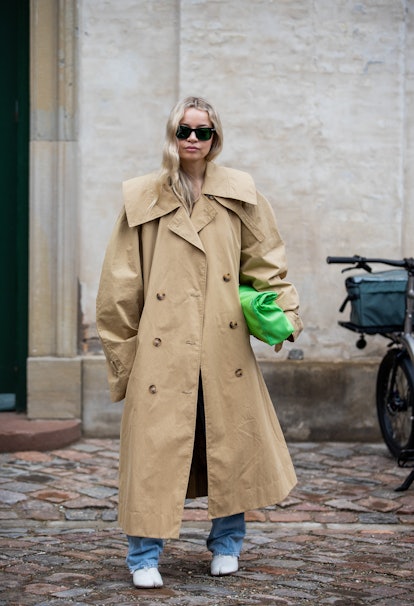 COPENHAGEN, DENMARK - FEBRUARY 02: Stephanie Broek seen wearing trench coat, green bag outside Stine...