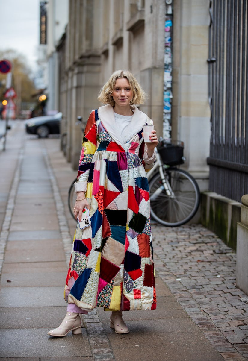 COPENHAGEN, DENMARK - FEBRUARY 02: A guest is seen wearing multi colored coat with patches outside S...