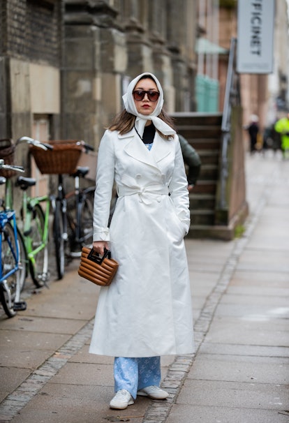 COPENHAGEN, DENMARK - FEBRUARY 02: Betty Bachz is seen wearing head scarf, white trench coat, brown ...