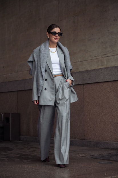 COPENHAGEN, DENMARK - FEBRUARY 03: Darja Barannik wearing grey pants, white top and grey jacket with...