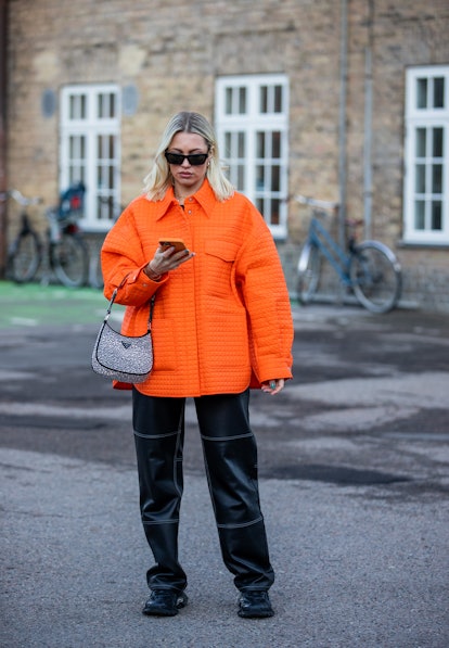 COPENHAGEN, DENMARK - FEBRUARY 02: Caroline Ebo seen wearing Prada bag, orange jacket, black pants o...