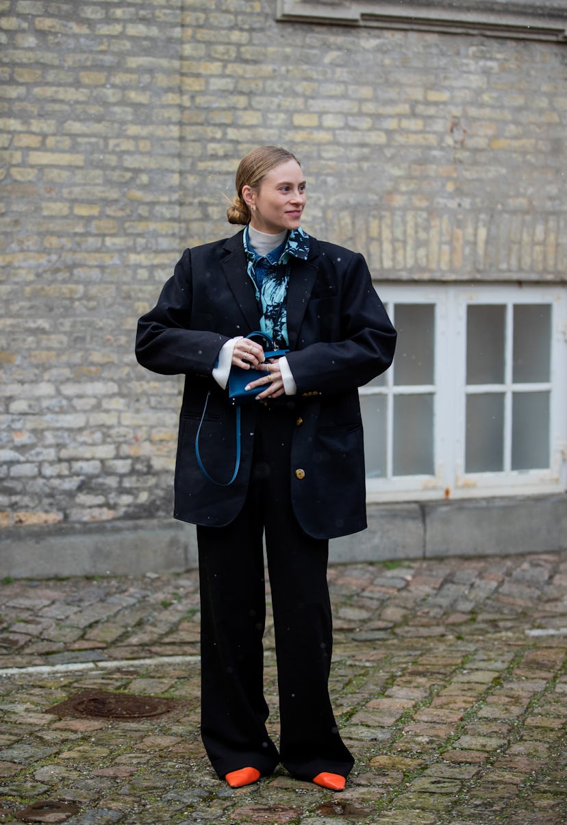 COPENHAGEN, DENMARK - FEBRUARY 02: Tine Andrea seen wearing blue Hermes bag, oversized jacket outsid...