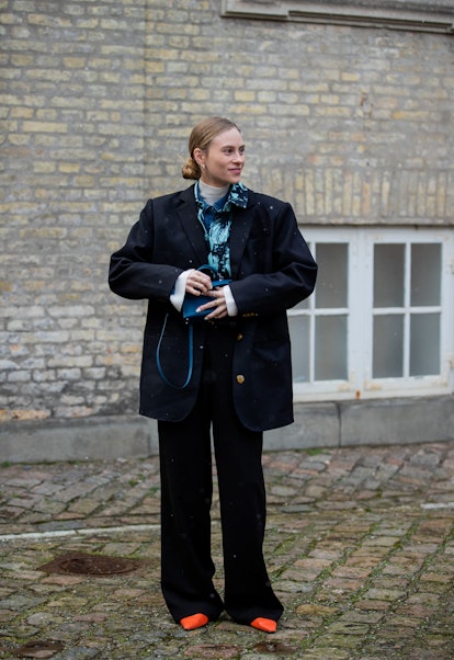 COPENHAGEN, DENMARK - FEBRUARY 02: Tine Andrea seen wearing blue Hermes bag, oversized jacket outsid...