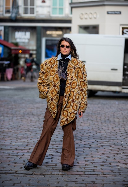 COPENHAGEN, DENMARK - FEBRUARY 02: A guest is seen wearing oversized blazer, brown pants outside Fas...