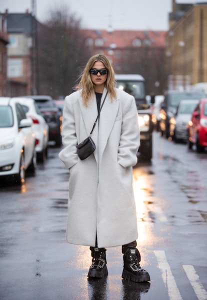 COPENHAGEN, DENMARK - FEBRUARY 01: Alessa Winter wearing white coat, black Prada bag &  outside The ...