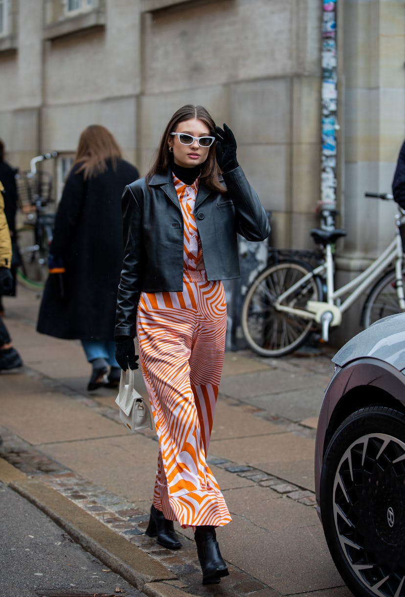 COPENHAGEN, DENMARK - FEBRUARY 02: Emilie Billington seen wearing black leather jacket, orange white...