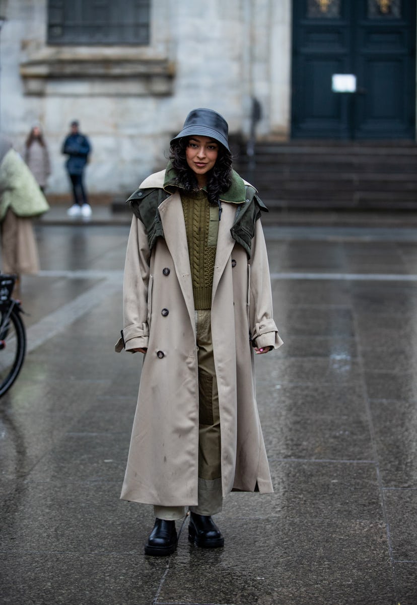 COPENHAGEN, DENMARK - FEBRUARY 01: A guest is seen wearing bucket hat, trench coat outside Lovechild...