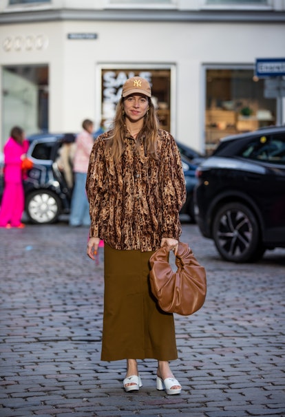 COPENHAGEN, DENMARK - FEBRUARY 02: Trine Kjaer seen wearing cap, brown skirt, bag, jacket outside Fa...