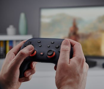 Detail of hands holding a Google Stadia video game controller, taken on November 27, 2019. (Photo by...