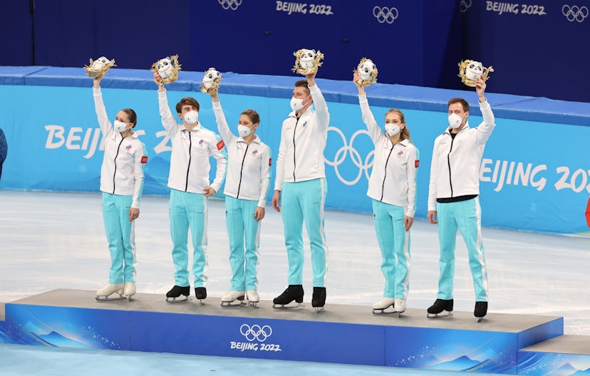 BEIJING, CHINA - FEBRUARY 07: Gold medalists Team ROC celebrate during the Team Event flower ceremon...