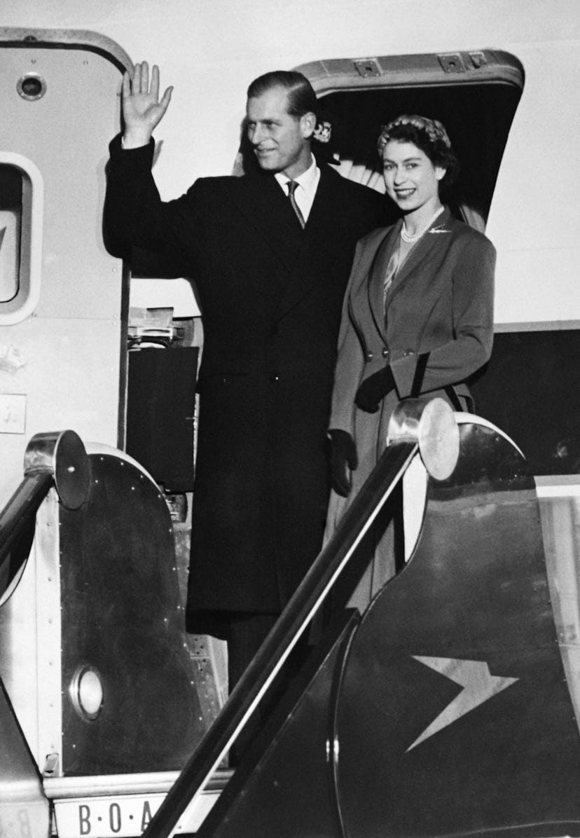 Queen Elizabeth II and Prince Philip, Duke of Edinburgh wave before a departure at the airport in 19...