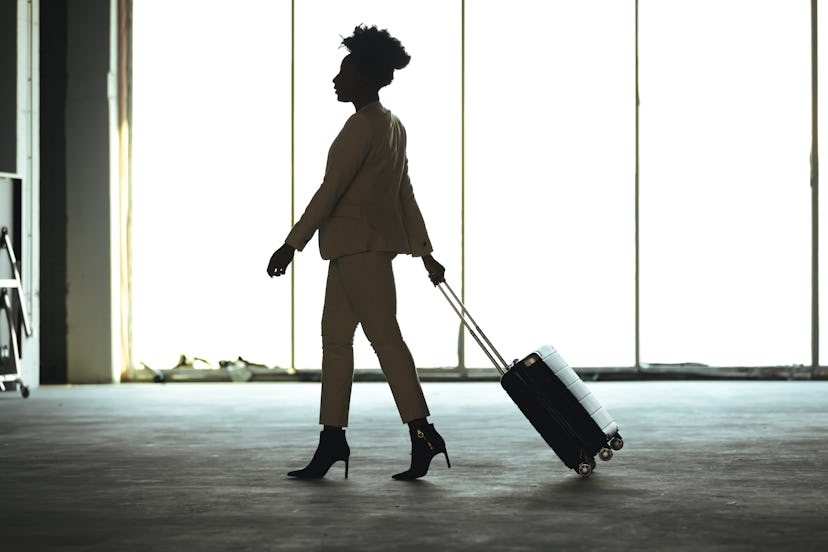 Businesswoman with suitcase in airport