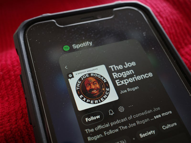 This illustration photo shows the Spotify page for "The Joe Rogan Experience" podcast displayed on a...