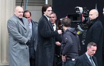 Actor Robert Pattinson (centre) on the set of The Batman in Liverpool wearing a coat which has been ...