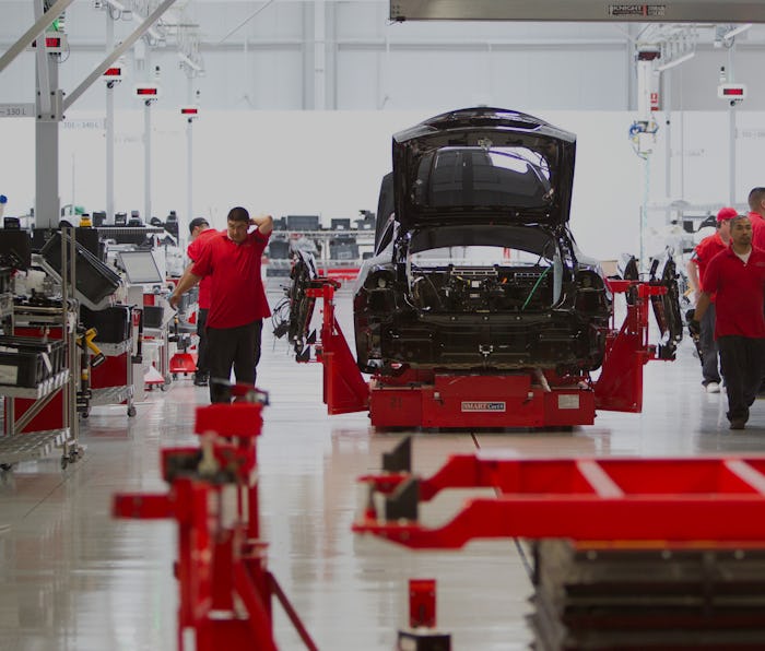 Workmen assemble a Model S sedan at the Tesla auto plant in Fremont, Calif. Tuesday, June 12, 2012. ...