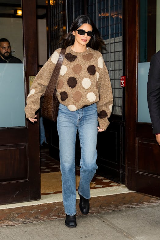 Kendall Jenner wears brown polka dot Acne Studios sweater.